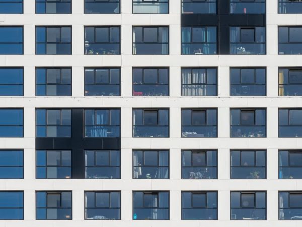 Close-up view of a modern white building facade with grid-like windows in Delft, Netherlands.